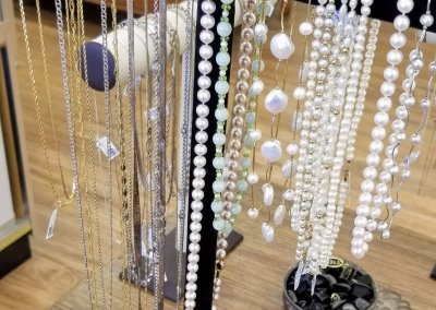 Yellow Gold, White Gold, and Pearl Necklaces on Display